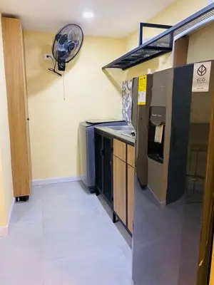 a kitchen with a stove and a fan on the wall at Laguito Houstel Small in Cartagena de Indias