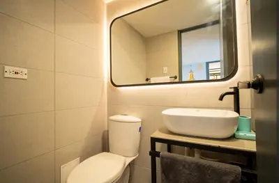 a bathroom with a sink and a toilet and a mirror at Laguito Houstel Small in Cartagena de Indias