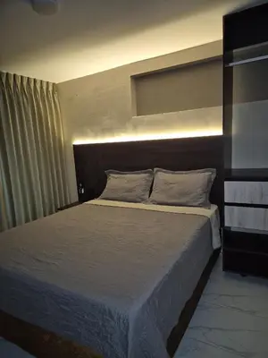 a bedroom with a large bed with a headboard at Laureles del parque loft in Barranquilla
