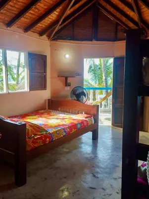 a bedroom with a bed in a room with windows at Cabañas Kosta Azul in San Bernardo del Viento