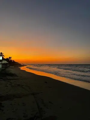 a sunset on a beach with the ocean at Cabañas Kosta Azul in San Bernardo del Viento