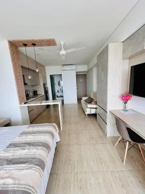 a large room with a bed and a living room at Hermosa APARTASUITE EN CARTAGENA!! in Cartagena de Indias