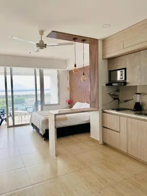 a kitchen with a bed and a table in a room at Hermosa APARTASUITE EN CARTAGENA!! in Cartagena de Indias