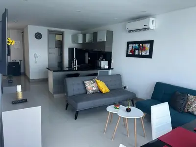 a living room with a couch and a table at HERMOSO APARTAMENTO VISTA AL MAR PALMETTO SUNSET-El Laguito in Cartagena de Indias