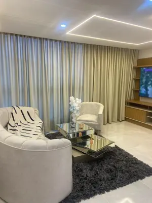 a living room with a white couch and a glass table at Lindo apartamento en el norte in Barranquilla