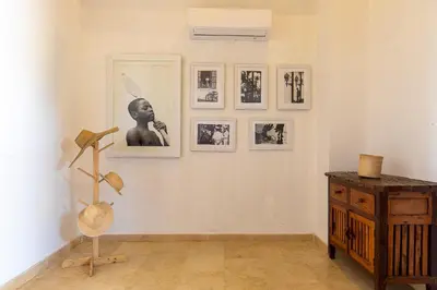 a room with pictures on the wall and a table at Cabaña Tio Chin in Coveñas