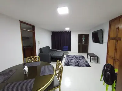 a living room with a table and a couch at Apartamento para carnavales in Barranquilla