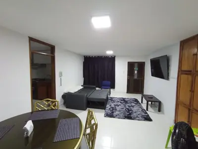 a living room with a couch and a table at Apartamento para carnavales in Barranquilla