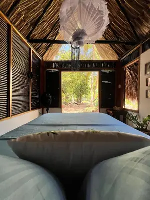 a large bed in a room with a large window at Hospedaje VILLA CRETA in Isla Fuerte