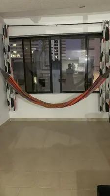 a room with a window with a rope on it at Duplex playa y mar in Cartagena de Indias