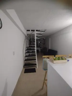 a spiral staircase in a room with a living room at Duplex playa y mar in Cartagena de Indias
