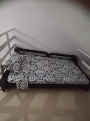 a bed with a black and white blanket on it at Duplex playa y mar in Cartagena de Indias