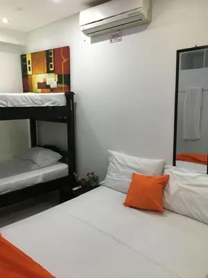 a room with two bunk beds and an orange pillow at Valmar apartamentos in Cartagena de Indias
