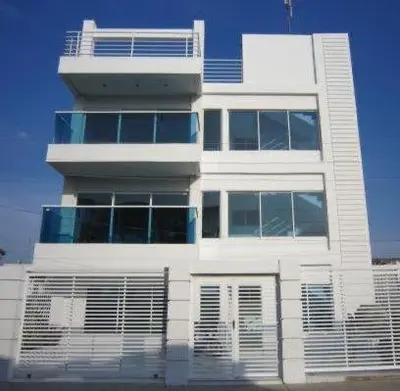a tall white building with a lot of windows at Valmar apartamentos in Cartagena de Indias