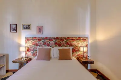 a bedroom with a large white bed with two lamps at Bololá Hotel in Cartagena de Indias
