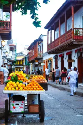 a cart full of oranges on a city street at Bololá Hotel in Cartagena de Indias