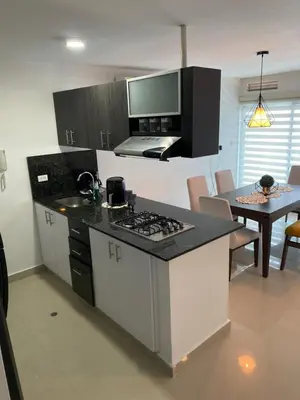 a kitchen with a counter top and a kitchen with a table at Modern Duplex en Riomar BQuilla in Barranquilla