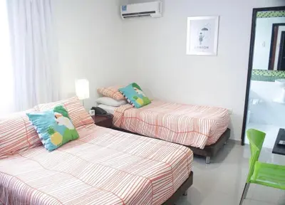 a living room with two beds and a couch at Golden House Apartments - 2 Bedrooms in Barranquilla