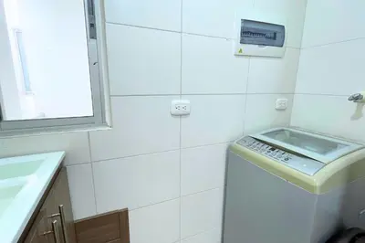 a bathroom with a sink and a washing machine at Apartmento En Miramar in Barranquilla