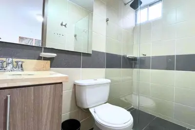 a bathroom with a toilet and a sink and a shower at Apartmento En Miramar in Barranquilla
