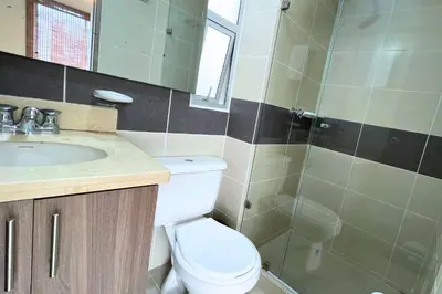a bathroom with a toilet and a sink and a shower at Apartmento En Miramar in Barranquilla