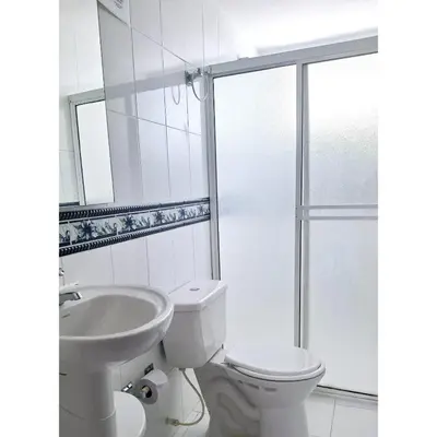 a white bathroom with a toilet and a sink at Golden House Studio Deluxe in Barranquilla