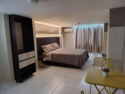 a bedroom with a bed and a television in it at Laureles del parque Loft in Barranquilla