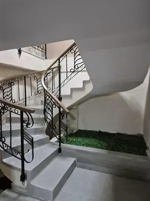 a spiral staircase with a green grass underneath it at Laureles del parque Loft in Barranquilla