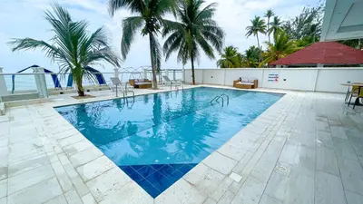 a swimming pool with palm trees in the background at Magico Apartamento Frente al Mar 3 Habitaciones TV52 in Coveñas