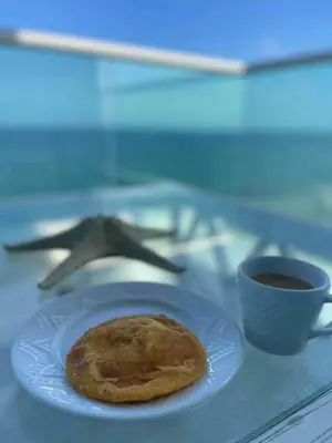 a plate with a cookie and a cup of coffee at Lovely apartment in front the beach in Coveñas