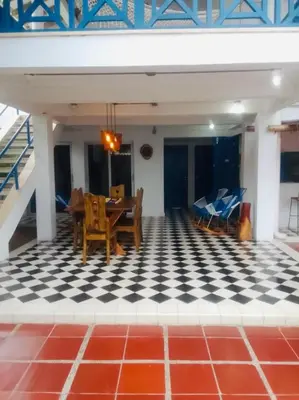 a dining room with a table and chairs on a checkered floor at Cuatro Palmas Beach House in Cartagena de Indias