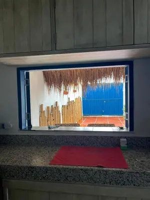 a window with a red mat on a counter at Cuatro Palmas Beach House in Cartagena de Indias