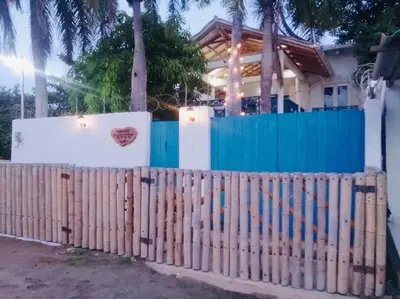 a wooden fence in front of a house at Cuatro Palmas Beach House in Cartagena de Indias