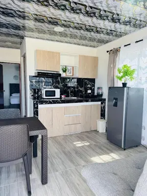 a kitchen with a table and a refrigerator in it at Apartamentos el mochilero frente a la playa piso 2 apto 4 in Cartagena de Indias