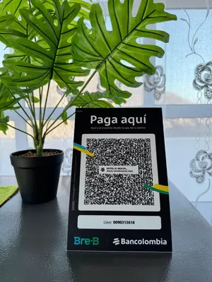 a tablet on a table next to a potted plant at Apartamentos el mochilero frente a la playa piso 2 apto 4 in Cartagena de Indias