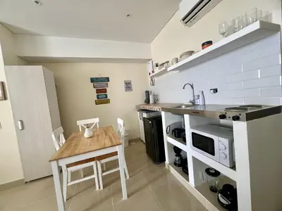 a small kitchen with a table and a microwave at Beautiful Studio close to the beach in Cartagena de Indias