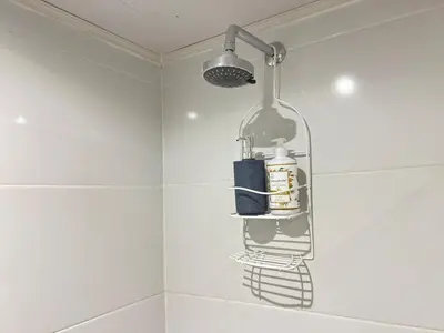 a bathroom with a shower with a glass bottle on the wall at Beautiful Studio close to the beach in Cartagena de Indias