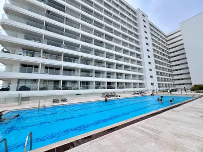 a swimming pool in front of a large building at Beautiful Studio close to the beach in Cartagena de Indias