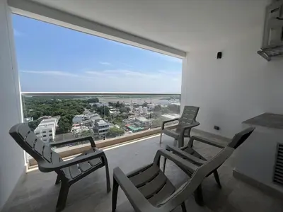 a room with two chairs and a large window at Beautiful Studio close to the beach in Cartagena de Indias