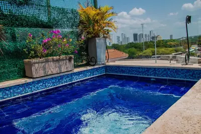 a swimming pool with blue tiles on a building at Nautilus urban loft in Cartagena de Indias