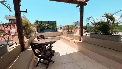 a patio with a table and chairs on a balcony at Nautilus urban loft in Cartagena de Indias