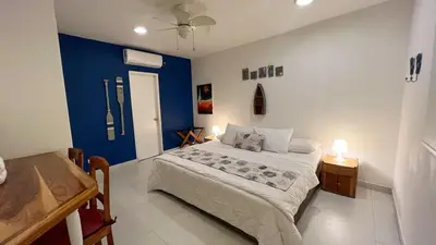 a bedroom with a bed and a blue wall at Nautilus urban loft in Cartagena de Indias