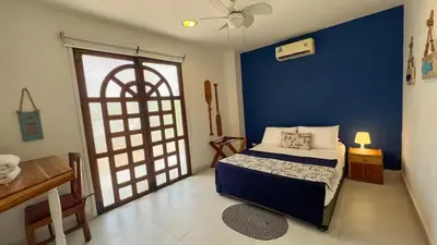 a bedroom with a bed and a blue wall at Nautilus urban loft in Cartagena de Indias