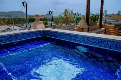 a swimming pool with blue tiles on a building at Nautilus urban loft in Cartagena de Indias