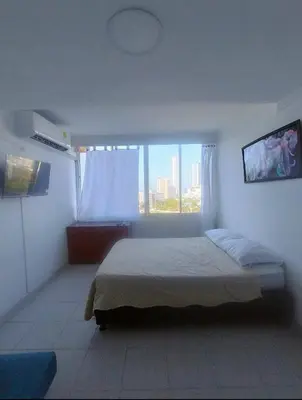 a bedroom with a bed and a large window at Cartagena in Cartagena de Indias
