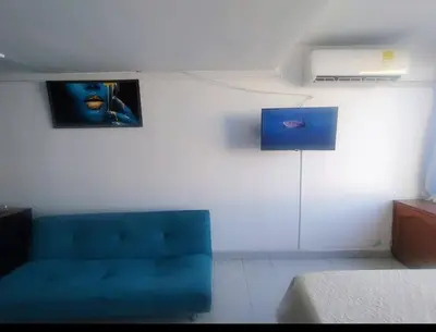 a living room with a blue couch in a room at Cartagena in Cartagena de Indias