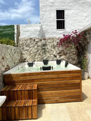 a bath tub sitting in front of a stone building at Casa Beatriz Luxury Colonial House in Cartagena de Indias