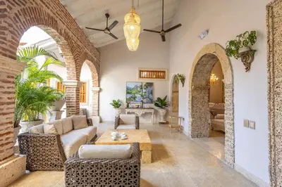a living room with a couch and a table at Casa Beatriz Luxury Colonial House in Cartagena de Indias