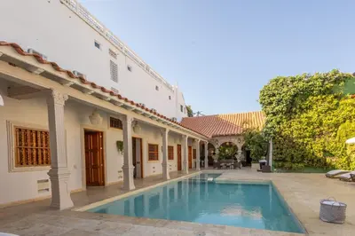 a swimming pool in the courtyard of a house at Casa Beatriz Luxury Colonial House in Cartagena de Indias