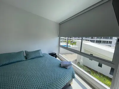 a bedroom with a bed and a large window at Moderno Apartamento en Cartagena in Cartagena de Indias